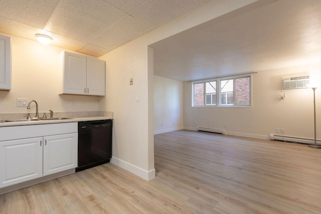 1624 Cannon St Unit 26, Helena, MT 59601 - kitchen featuring black dishwasher, a sink, a wall mounted AC, baseboard heating, and white cabinets