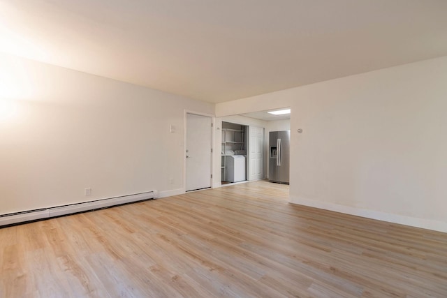 1624 Cannon St Unit 26, Helena, MT 59601 - spare room featuring washer and clothes dryer, light wood finished floors, baseboards, and a baseboard radiator