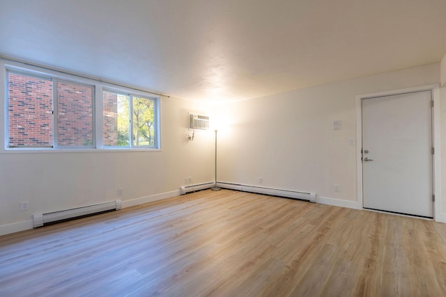 1624 Cannon St Unit 26, Helena, MT 59601 - empty room with a baseboard radiator, light wood-style flooring, baseboards, a baseboard heating unit, and a wall unit AC