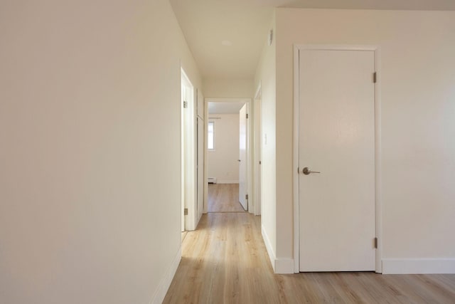 1624 Cannon St Unit 26, Helena, MT 59601 - hallway with light wood finished floors, baseboards, and a baseboard heating unit