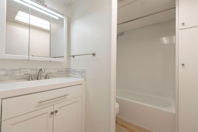 1624 Cannon St Unit 26, Helena, MT 59601 - bathroom with toilet, vanity, wood finished floors, shower / bath combination, and backsplash