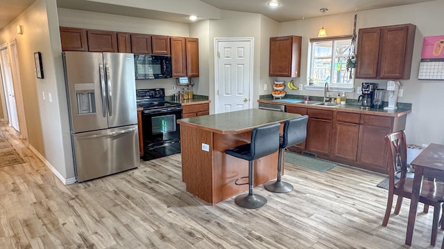 3319 Ivy Dr, Helena, MT 59602 - kitchen featuring black appliances, a sink, light wood-type flooring, and recessed lighting