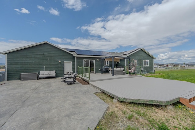 3319 Ivy Dr, Helena, MT 59602 - rear view of house with outdoor lounge area, a wooden deck, and solar panels