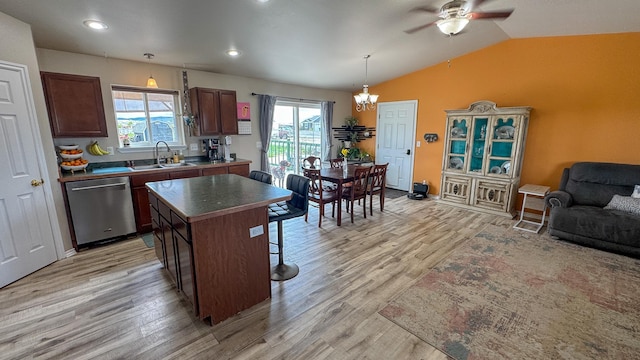 3319 Ivy Dr, Helena, MT 59602 - kitchen with dishwasher, a sink, light wood-type flooring, a breakfast bar, and lofted ceiling