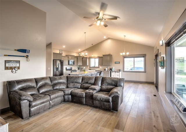 4731 Sea Ray Rd, Helena, MT 59602 - living area with a chandelier, a ceiling fan, light wood-type flooring, high vaulted ceiling, and baseboards