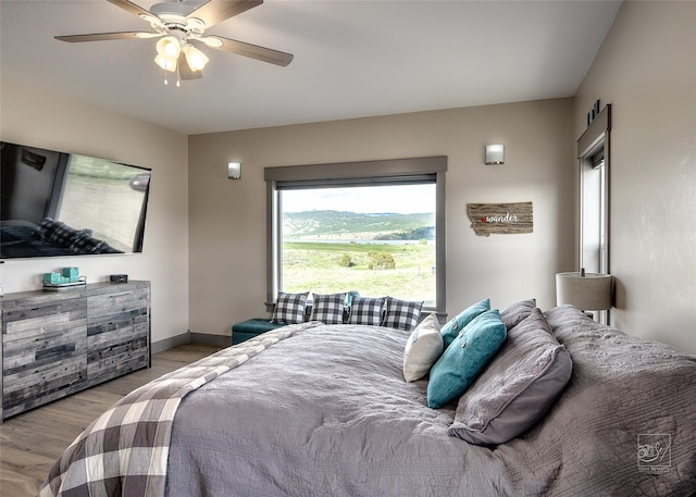 4731 Sea Ray Rd, Helena, MT 59602 - bedroom featuring wood finished floors, a ceiling fan, and baseboards