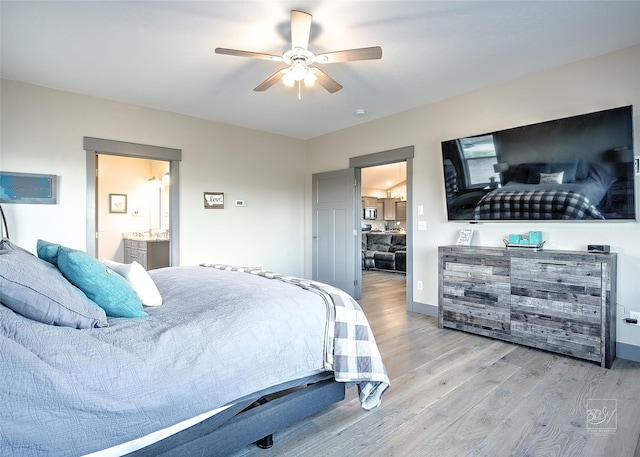 4731 Sea Ray Rd, Helena, MT 59602 - bedroom featuring wood finished floors, baseboards, ensuite bath, and ceiling fan