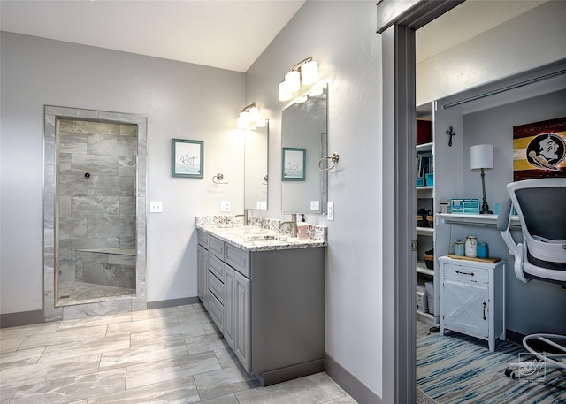 4731 Sea Ray Rd, Helena, MT 59602 - full bathroom with double vanity, a tile shower, and baseboards