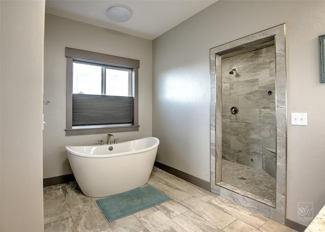 4731 Sea Ray Rd, Helena, MT 59602 - full bathroom featuring baseboards, marble look tiles, tiled shower, and a freestanding bath