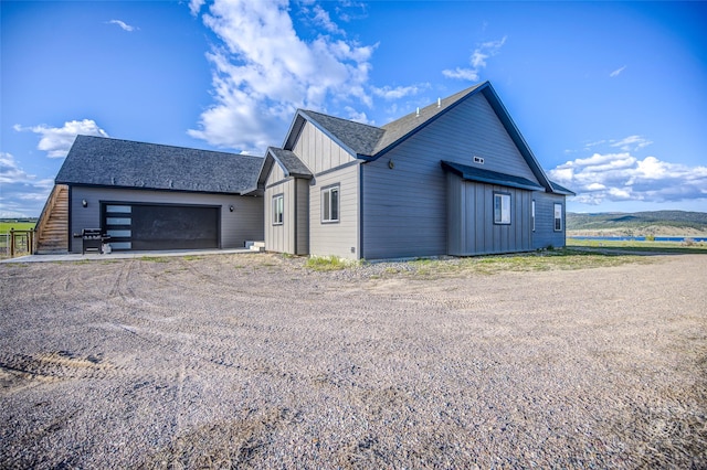 4731 Sea Ray Rd, Helena, MT 59602 - view of property exterior featuring board and batten siding, driveway, and roof with shingles