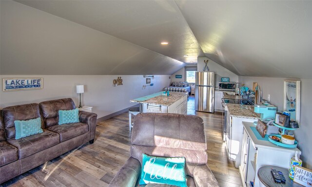 4731 Sea Ray Rd, Helena, MT 59602 - living area featuring wood finished floors, lofted ceiling, and baseboards