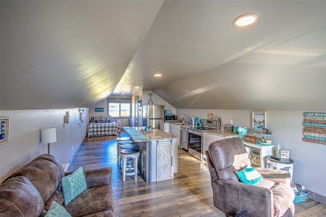 4731 Sea Ray Rd, Helena, MT 59602 - office area with a sink, wood finished floors, vaulted ceiling, and baseboards
