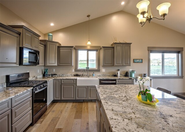 4731 Sea Ray Rd, Helena, MT 59602 - kitchen featuring black appliances, gray cabinetry, light wood-type flooring, a chandelier, and high vaulted ceiling