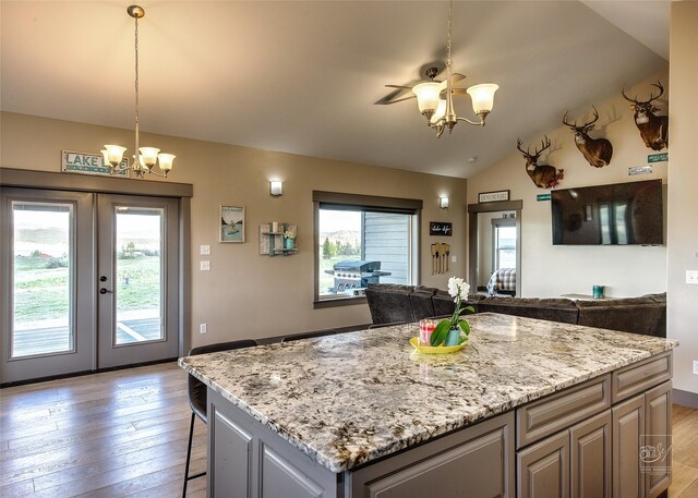 4731 Sea Ray Rd, Helena, MT 59602 - kitchen with a chandelier, open floor plan, light wood-style floors, french doors, and vaulted ceiling