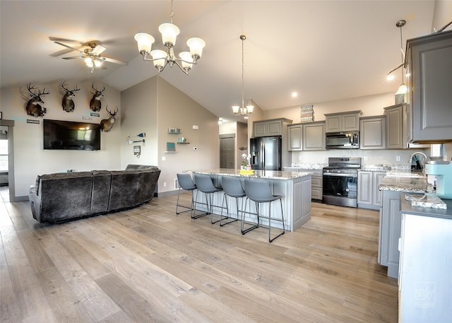 4731 Sea Ray Rd, Helena, MT 59602 - kitchen with appliances with stainless steel finishes, gray cabinets, a chandelier, a sink, and open floor plan