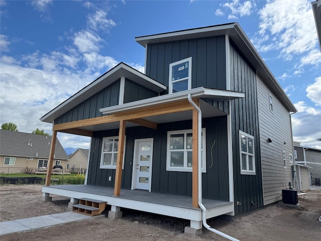 2283 Depot Way, Missoula, MT 59808 - view of front of house with board and batten siding, a porch, and central air condition unit