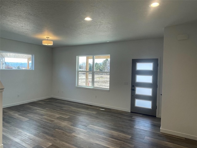 2283 Depot Way, Missoula, MT 59808 - foyer entrance featuring healthy amount of natural light, baseboards, dark wood-style floors, a textured ceiling, and recessed lighting