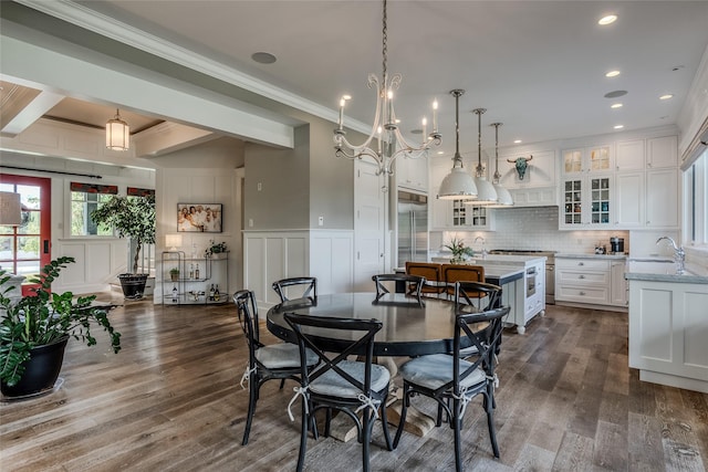 3070 River Lakes Dr, Whitefish, MT 59937 - dining room featuring a decorative wall, dark wood-type flooring, a chandelier, beamed ceiling, and crown molding