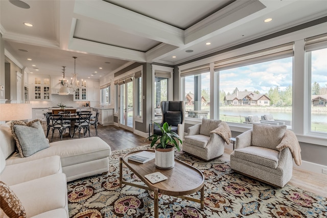 3070 River Lakes Dr, Whitefish, MT 59937 - living room with plenty of natural light, crown molding, dark wood-style floors, recessed lighting, and a water view