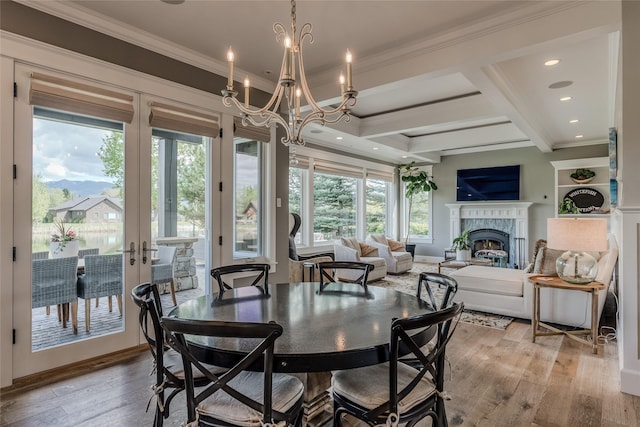 3070 River Lakes Dr, Whitefish, MT 59937 - dining area featuring crown molding, a chandelier, light wood-type flooring, a premium fireplace, and beam ceiling