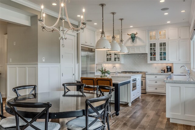 3070 River Lakes Dr, Whitefish, MT 59937 - kitchen with a sink, high quality appliances, white cabinetry, crown molding, and dark wood-style floors