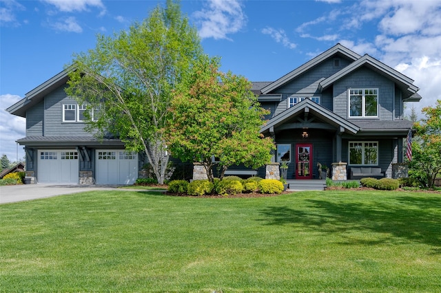 3070 River Lakes Dr, Whitefish, MT 59937 - craftsman inspired home featuring stone siding, a front yard, an attached garage, and driveway