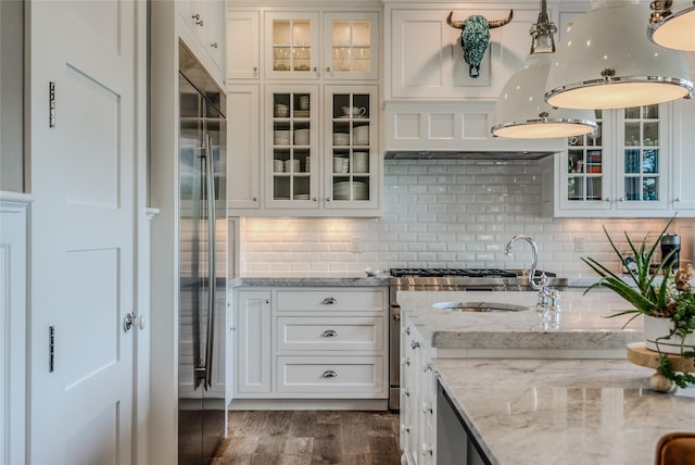 3070 River Lakes Dr, Whitefish, MT 59937 - kitchen featuring dark wood finished floors, white cabinetry, glass insert cabinets, and decorative backsplash