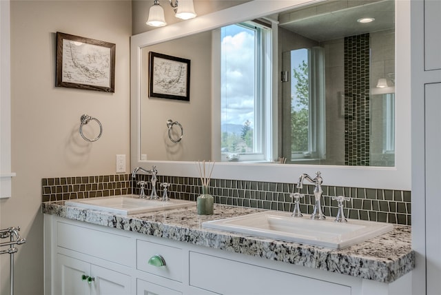 3070 River Lakes Dr, Whitefish, MT 59937 - bathroom featuring backsplash, double vanity, and healthy amount of natural light
