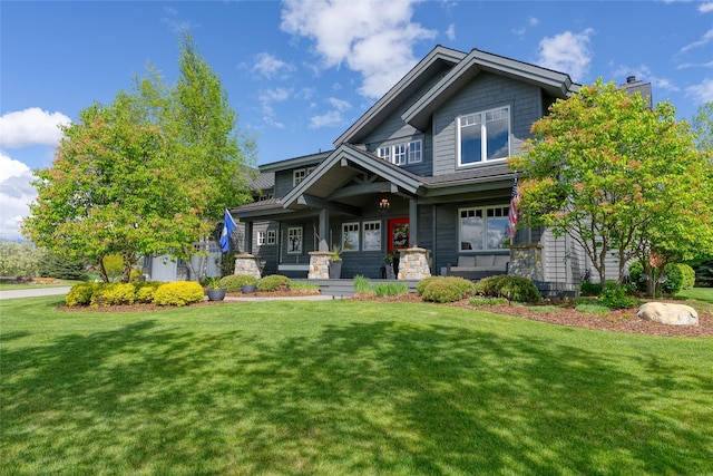 3070 River Lakes Dr, Whitefish, MT 59937 - craftsman-style house featuring covered porch, a front yard, and a chimney