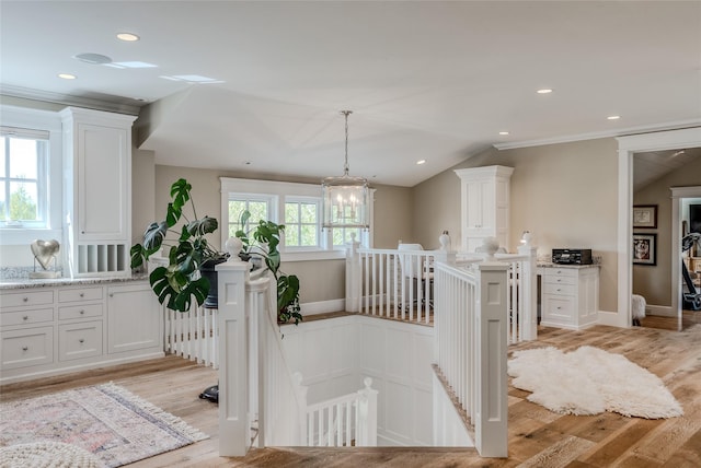 3070 River Lakes Dr, Whitefish, MT 59937 - hallway with an upstairs landing, light wood finished floors, ornamental molding, a chandelier, and recessed lighting