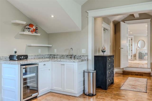 3070 River Lakes Dr, Whitefish, MT 59937 - indoor wet bar with beverage cooler, vaulted ceiling, light wood finished floors, and recessed lighting