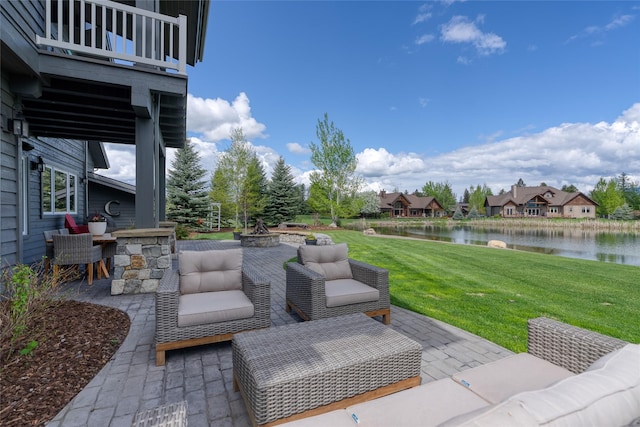 3070 River Lakes Dr, Whitefish, MT 59937 - view of patio / terrace with a water view, an outdoor living space with a fire pit, and a balcony