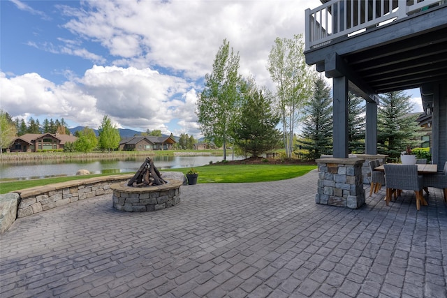 3070 River Lakes Dr, Whitefish, MT 59937 - view of patio featuring a water view, an outdoor fire pit, a balcony, outdoor dining space, and a residential view