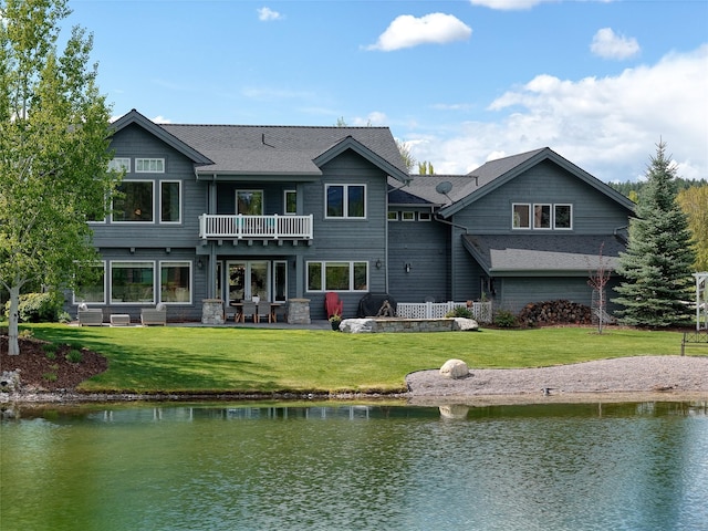 3070 River Lakes Dr, Whitefish, MT 59937 - back of house with a balcony, a water view, a lawn, and a patio