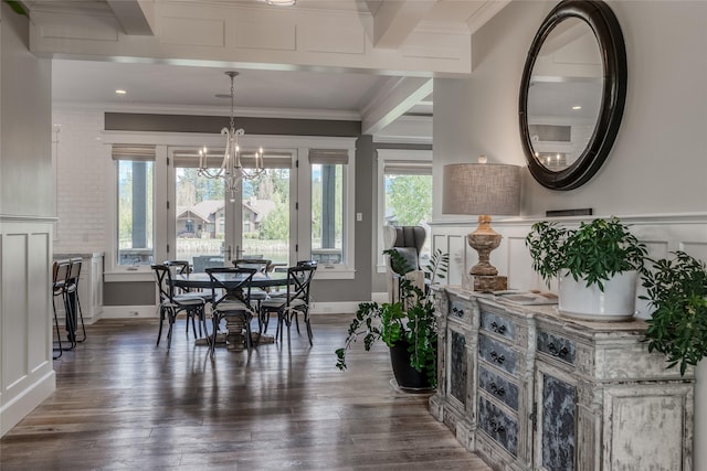 3070 River Lakes Dr, Whitefish, MT 59937 - dining room with crown molding, wood finished floors, a chandelier, a wainscoted wall, and a decorative wall