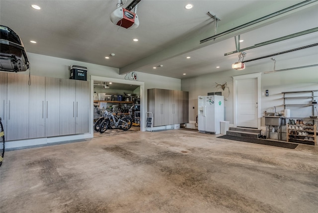 3070 River Lakes Dr, Whitefish, MT 59937 - garage featuring a garage door opener, white fridge with ice dispenser, and recessed lighting