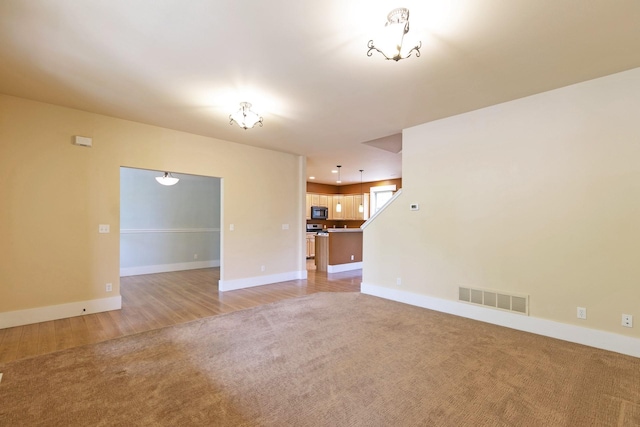 6021 Hobson Ln, Missoula, MT 59803 - unfurnished living room featuring light colored carpet and baseboards