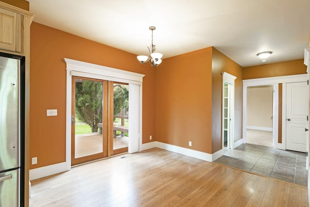 6021 Hobson Ln, Missoula, MT 59803 - unfurnished dining area with light wood-style flooring, a chandelier, baseboards, and french doors