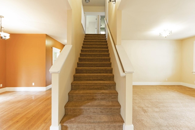 6021 Hobson Ln, Missoula, MT 59803 - stairs featuring baseboards, wood finished floors, and a chandelier