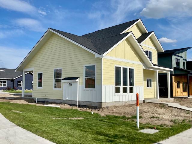 623 Holstein Way, Kalispell, MT 59901 - view of side of property featuring board and batten siding and a lawn