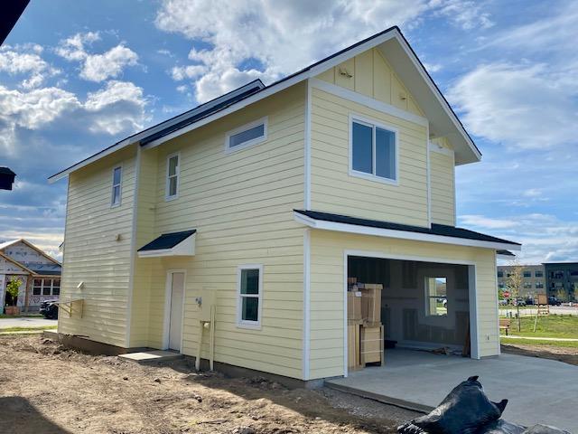623 Holstein Way, Kalispell, MT 59901 - back of house featuring a garage, board and batten siding, and concrete driveway