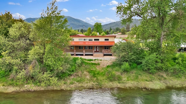 26 Two Rivers Rd, Saint Regis, MT 59866 - back of property with metal roof and a deck with water view
