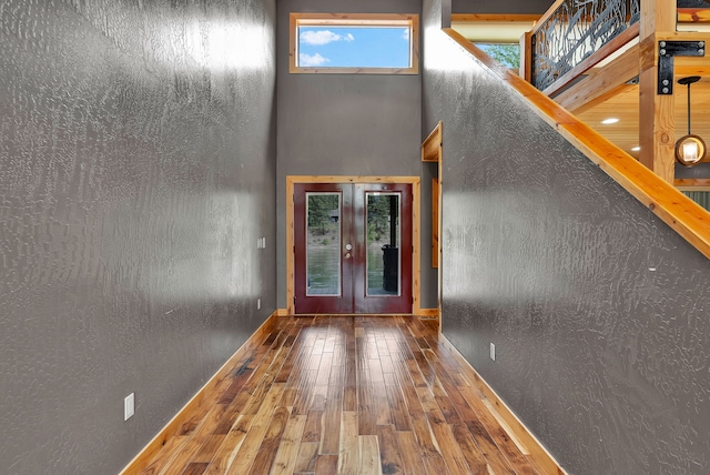 26 Two Rivers Rd, Saint Regis, MT 59866 - entrance foyer with french doors, hardwood / wood-style floors, a towering ceiling, stairs, and baseboards