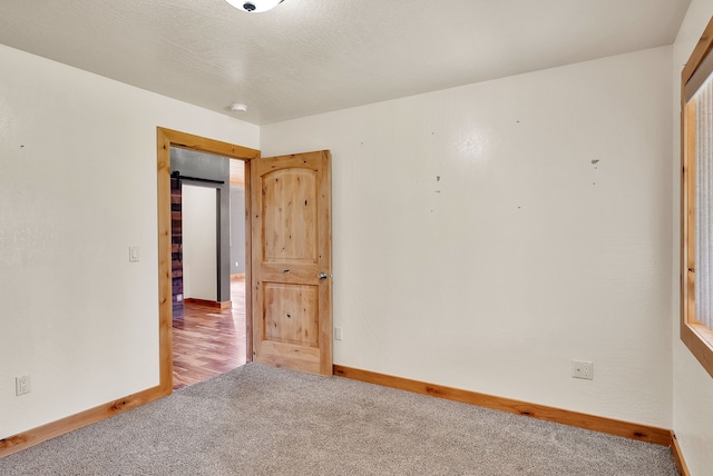 26 Two Rivers Rd, Saint Regis, MT 59866 - unfurnished room featuring baseboards, carpet, and a smoke detector