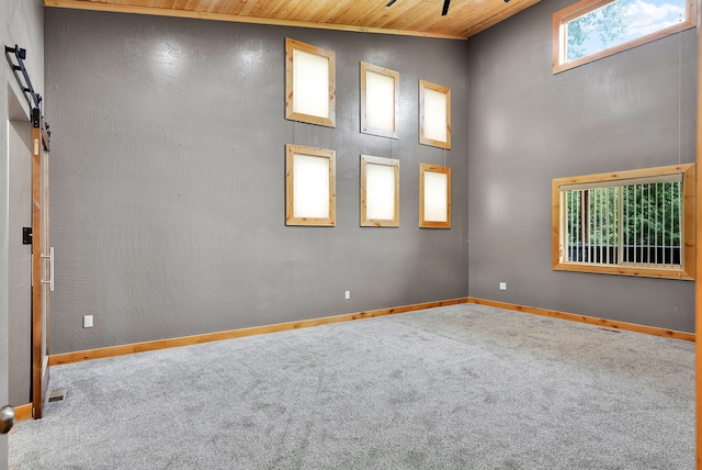 26 Two Rivers Rd, Saint Regis, MT 59866 - carpeted empty room featuring wooden ceiling and baseboards