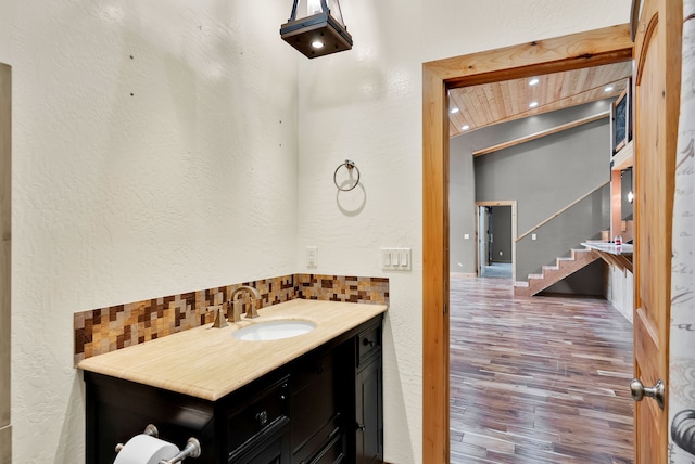 26 Two Rivers Rd, Saint Regis, MT 59866 - bathroom featuring backsplash, wood finished floors, vanity, and a textured wall