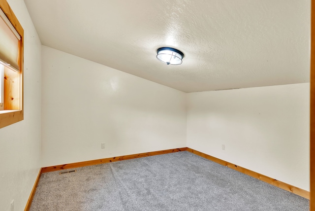 26 Two Rivers Rd, Saint Regis, MT 59866 - carpeted empty room with baseboards and a textured ceiling