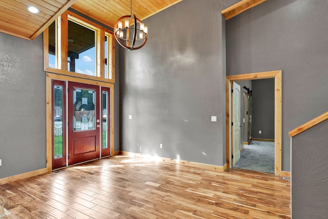 26 Two Rivers Rd, Saint Regis, MT 59866 - entrance foyer with wooden ceiling, wood finished floors, a chandelier, a towering ceiling, and a textured wall