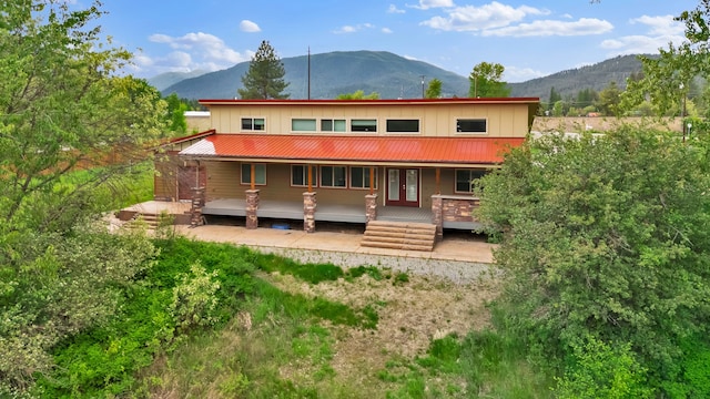 26 Two Rivers Rd, Saint Regis, MT 59866 - back of house featuring a mountain view, french doors, metal roof, and board and batten siding