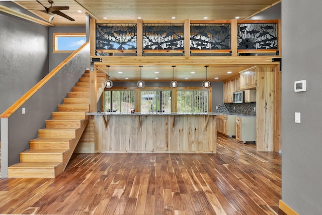 26 Two Rivers Rd, Saint Regis, MT 59866 - kitchen featuring wood-type flooring, a peninsula, plenty of natural light, a high ceiling, and ceiling fan